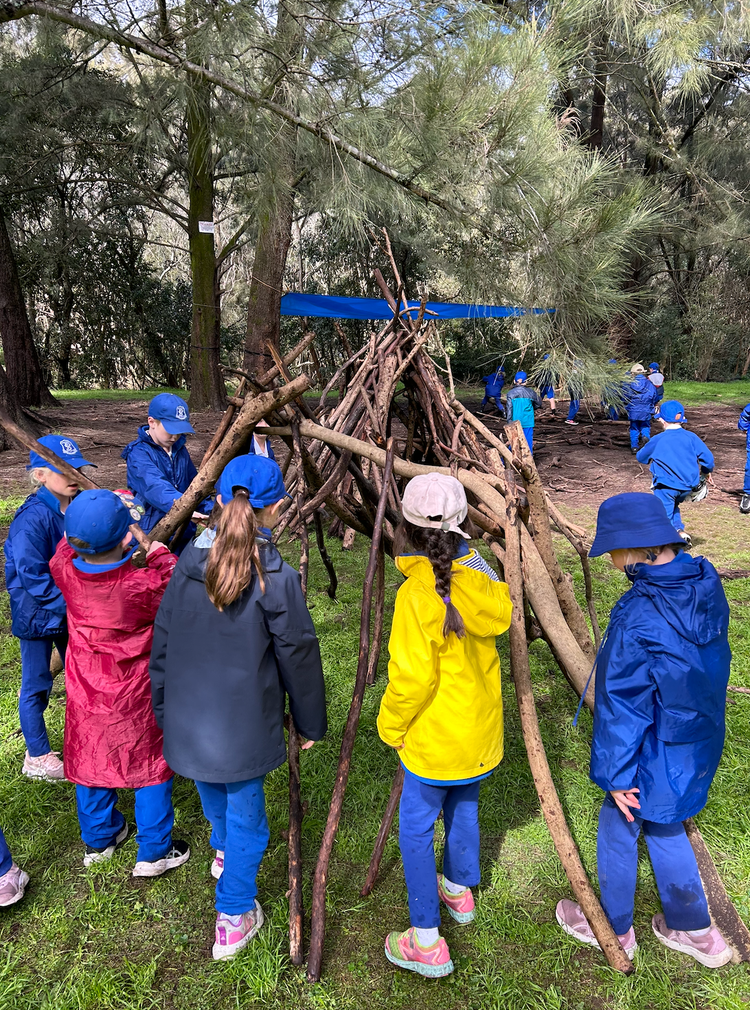 Group of students at a geography excursion creating a shelter